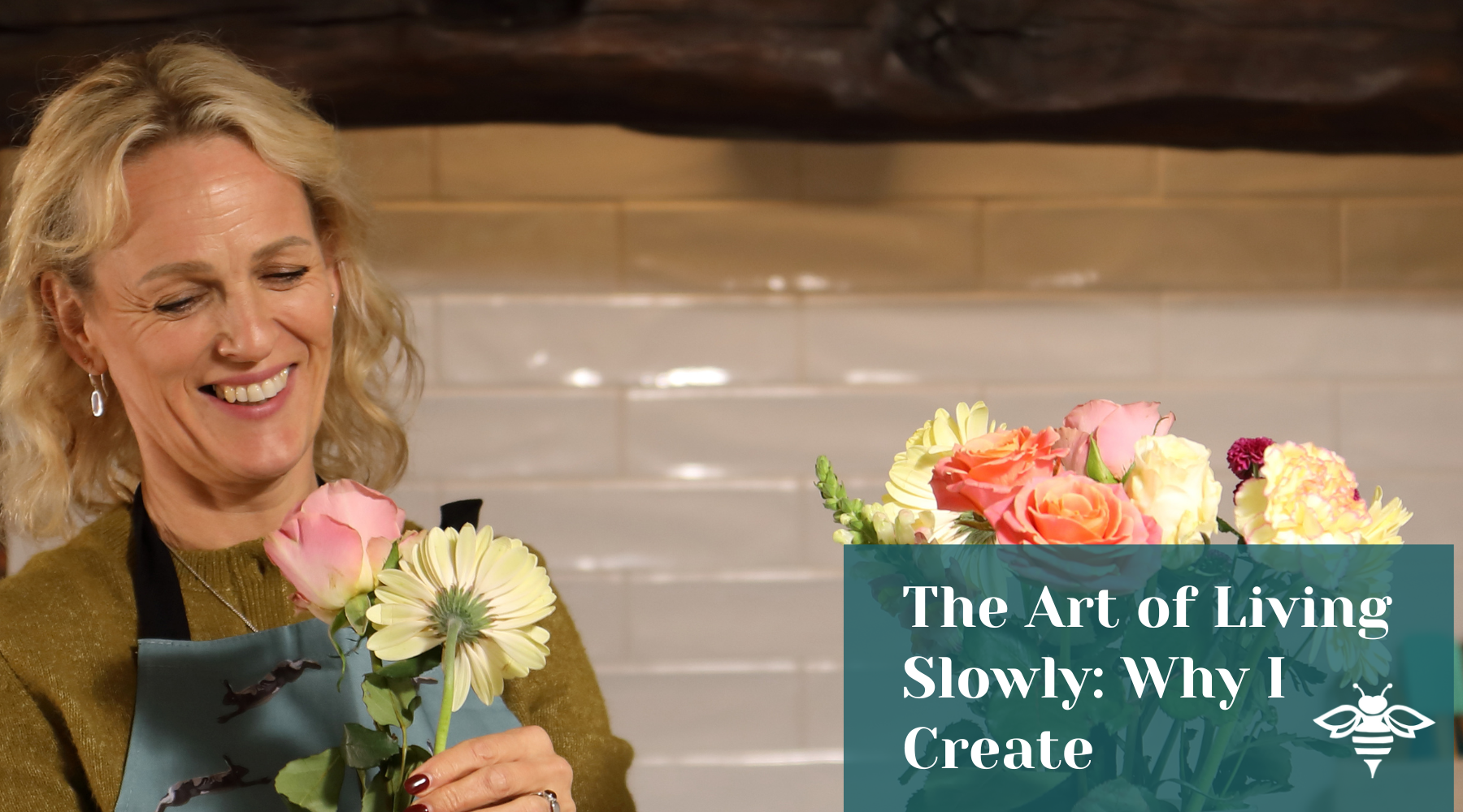 Hand-illustrated British Linens, worn whilst arranging flowers, showcasing Tracey Cooper’s slow living homeware collection.