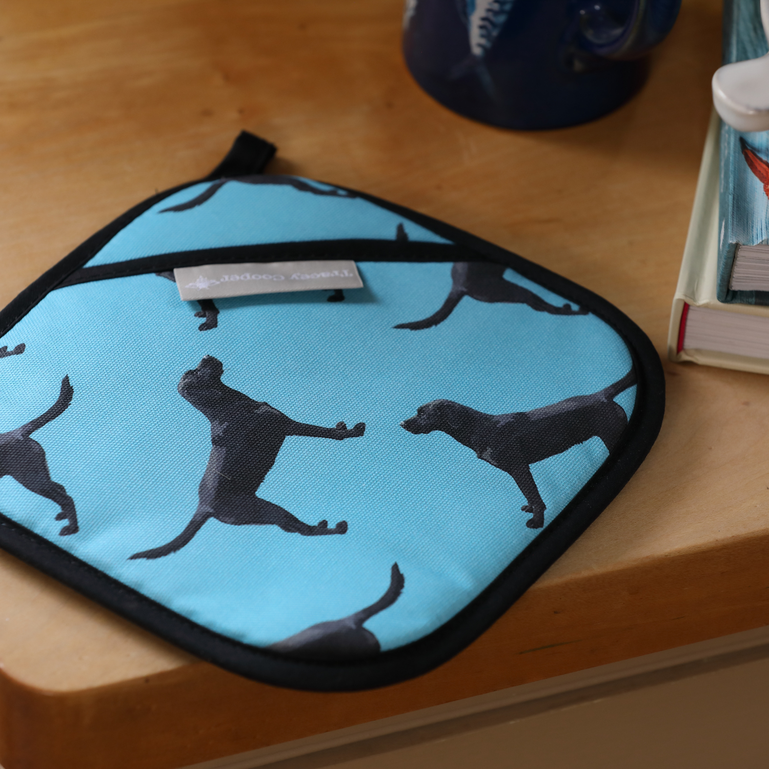 Black Labrador pot grab in blue