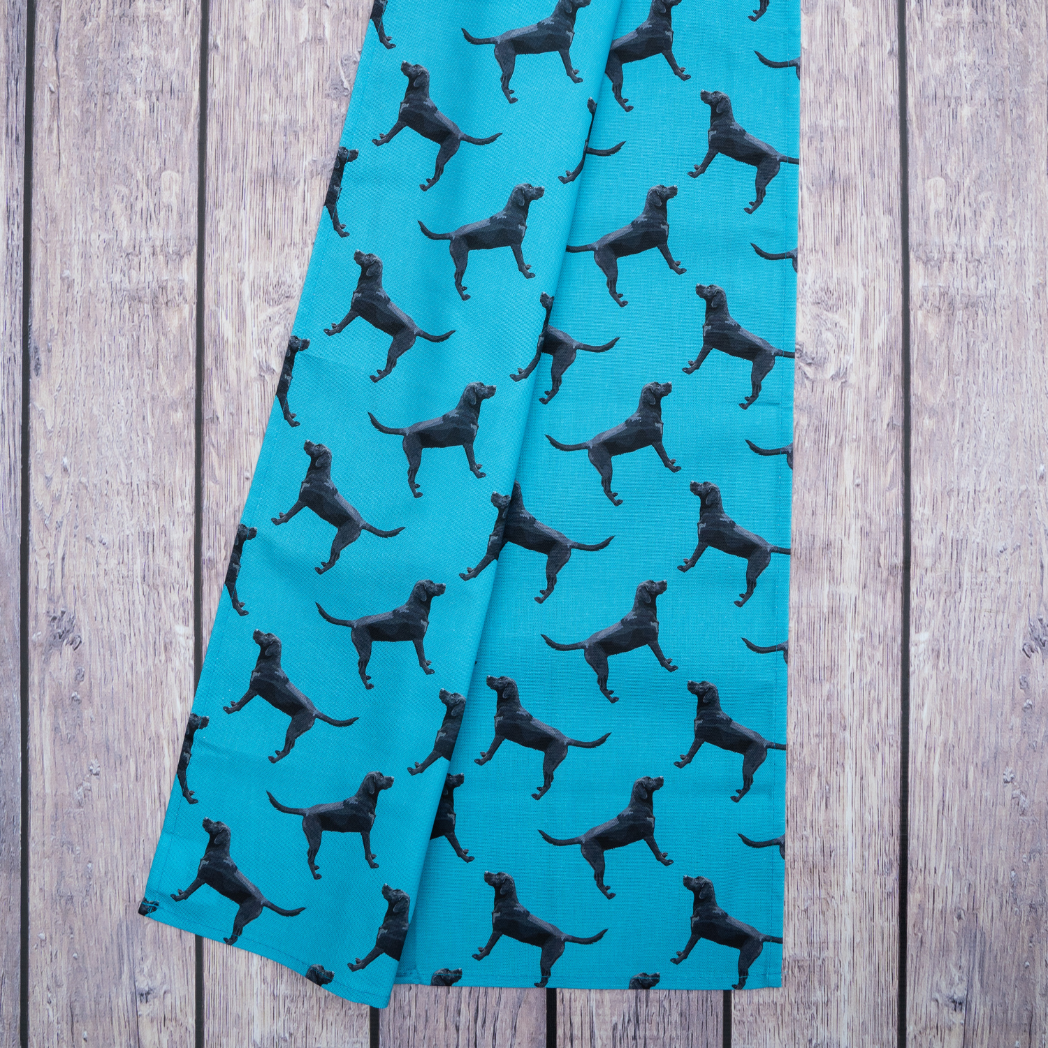 Black Lab tea towel on blue background