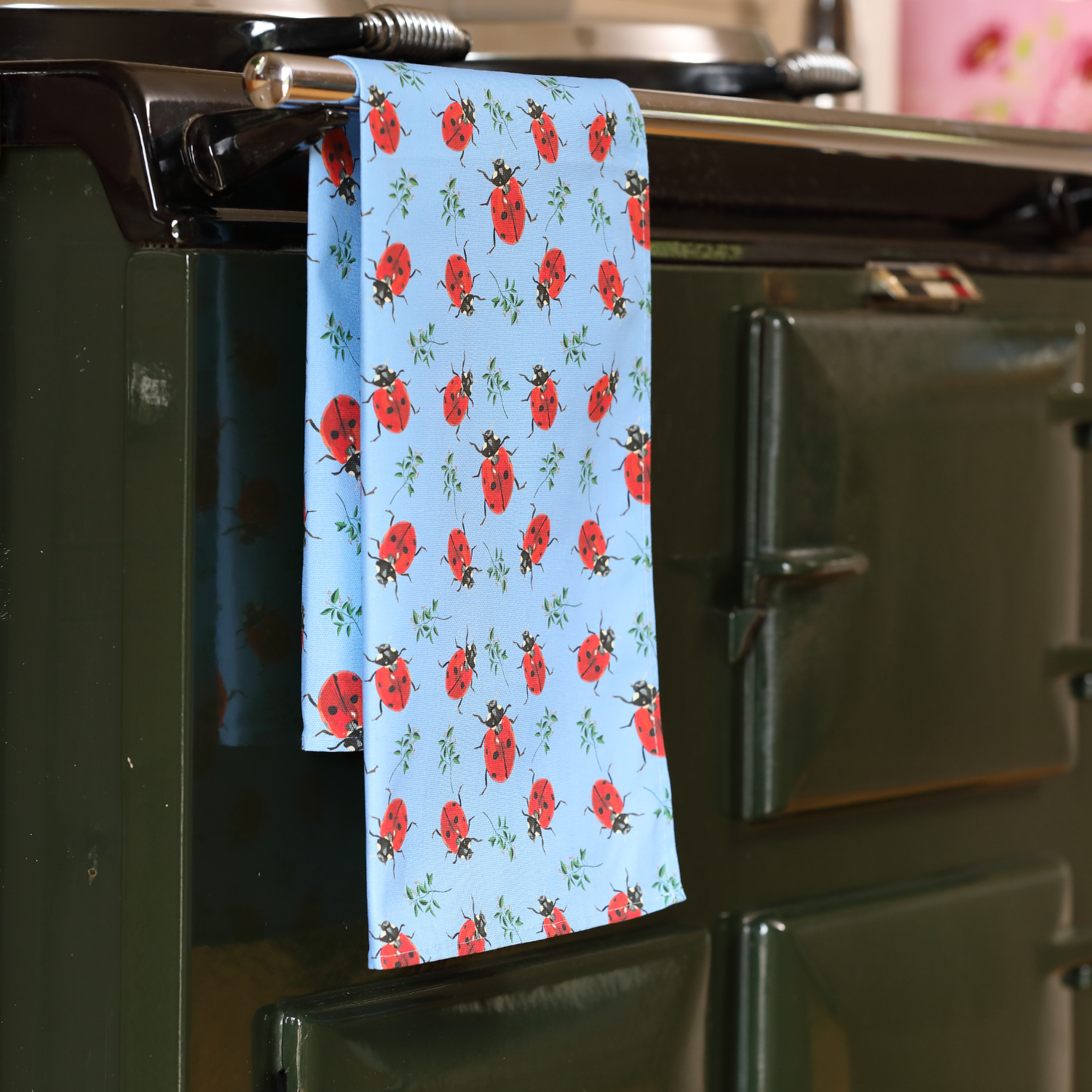 Hand-illustrated Ladybird Tea Towel by Tracey Cooper — 100% cotton, printed in the UK, featuring vibrant red and black ladybird designs.