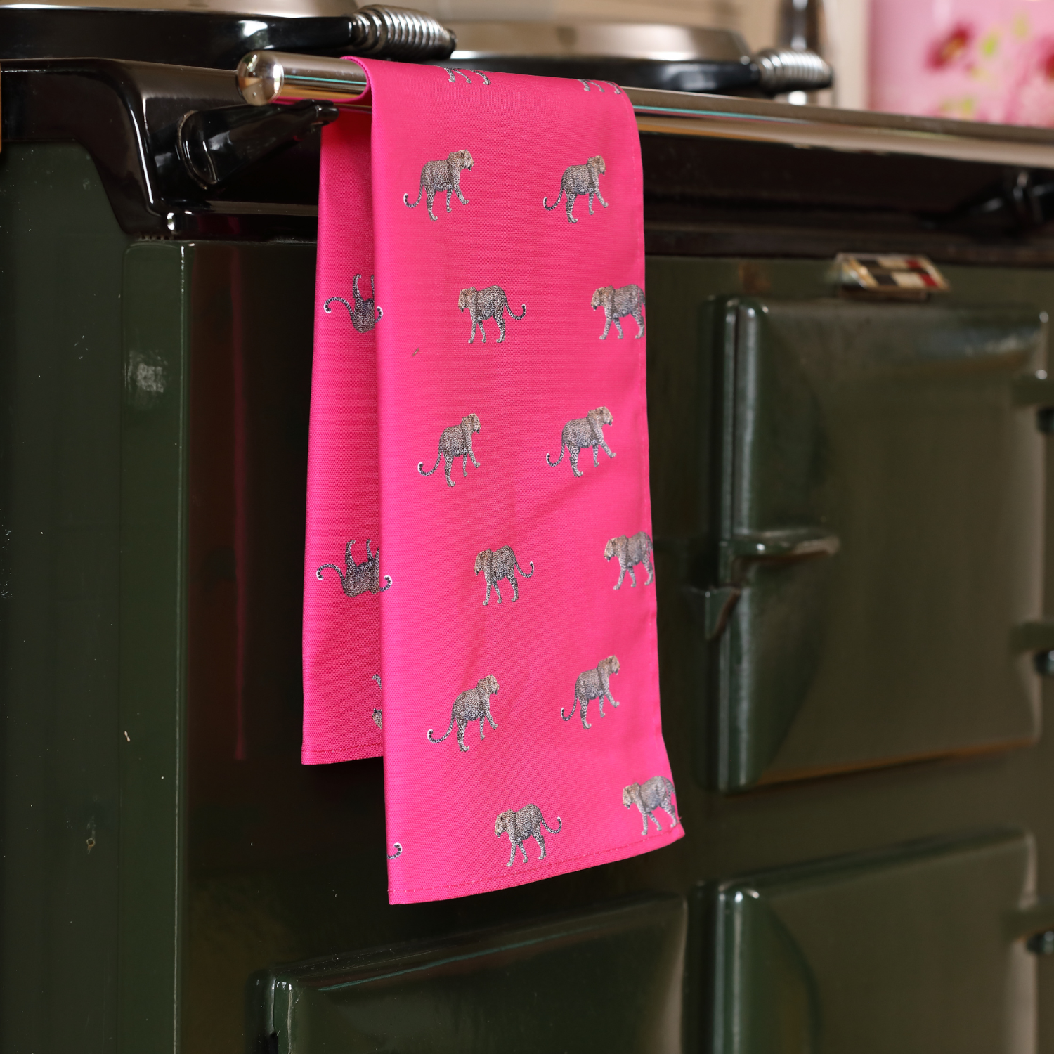Hand-illustrated Leopard Tea Towel by Tracey Cooper — 100% cotton, printed in the UK, featuring a striking leopard design on a bold pink background.
