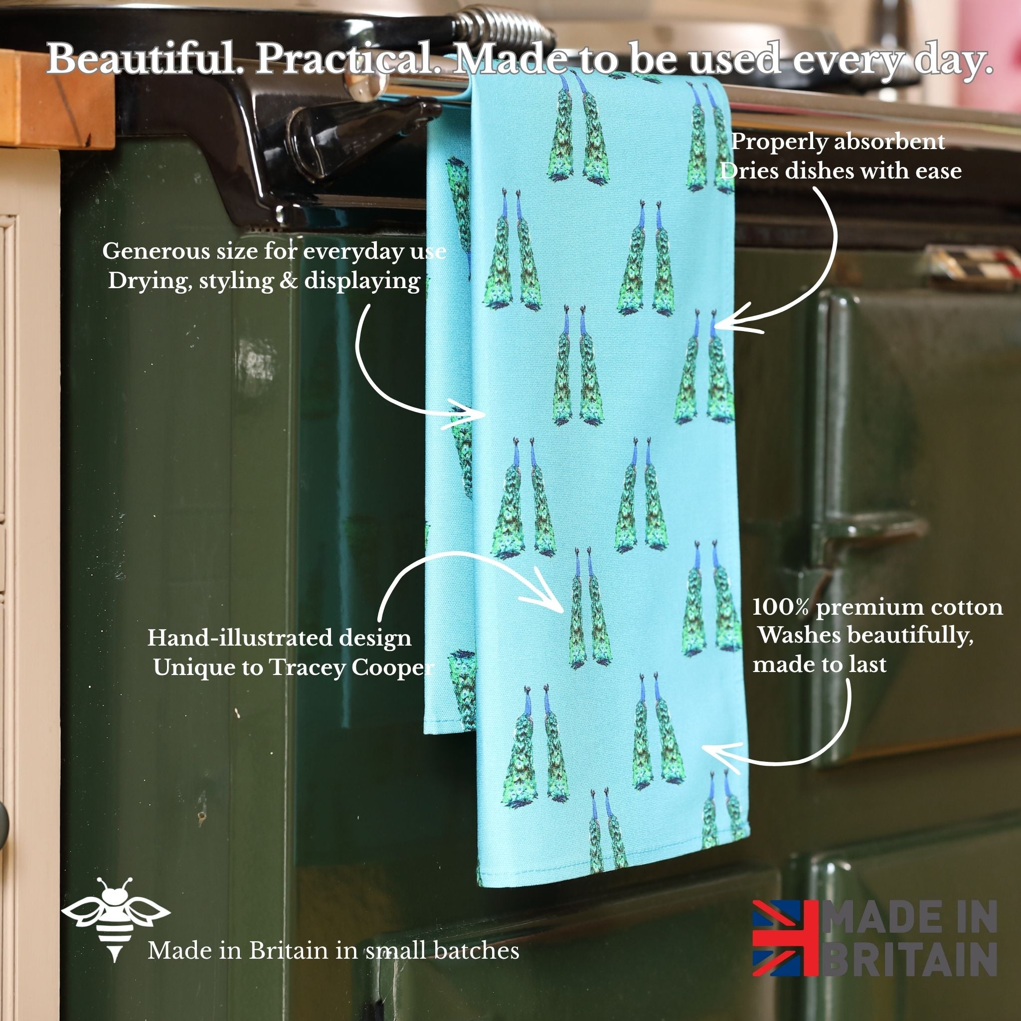 Teal towel with Peacock design hanging on a kitchen rack, with text describing its features.