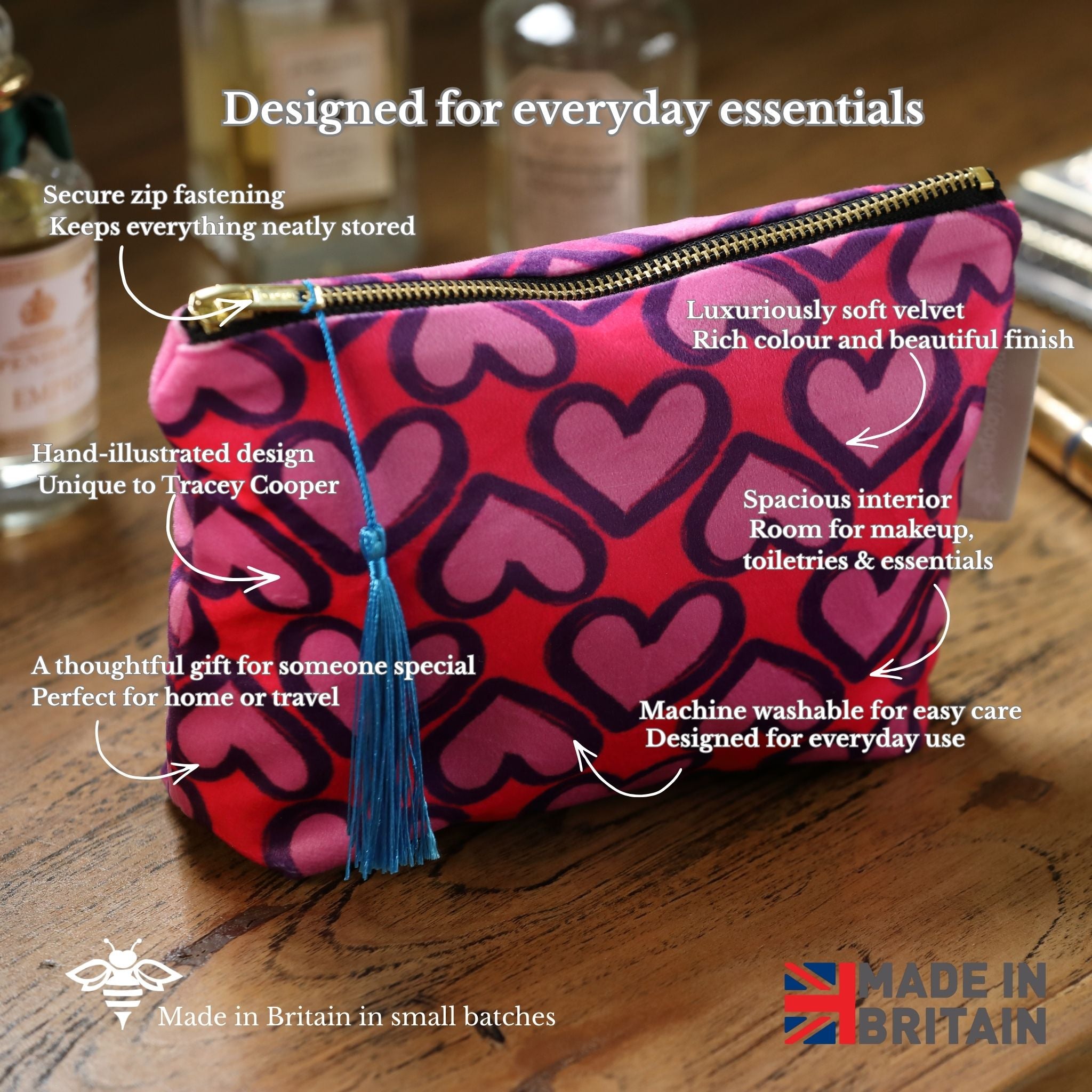 Pink makeup bag with heart pattern on a wooden surface, featuring text about its features.