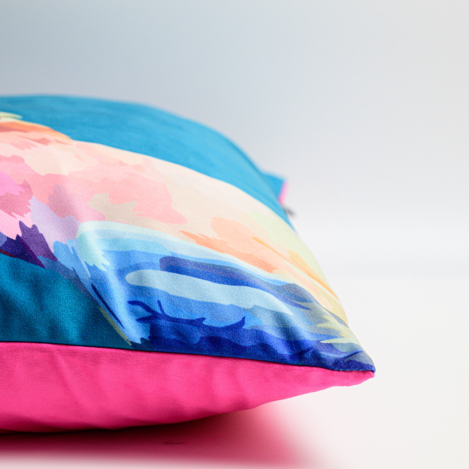 A blue velvet cushion featuring an illustration of a Pink Cockatoo side view