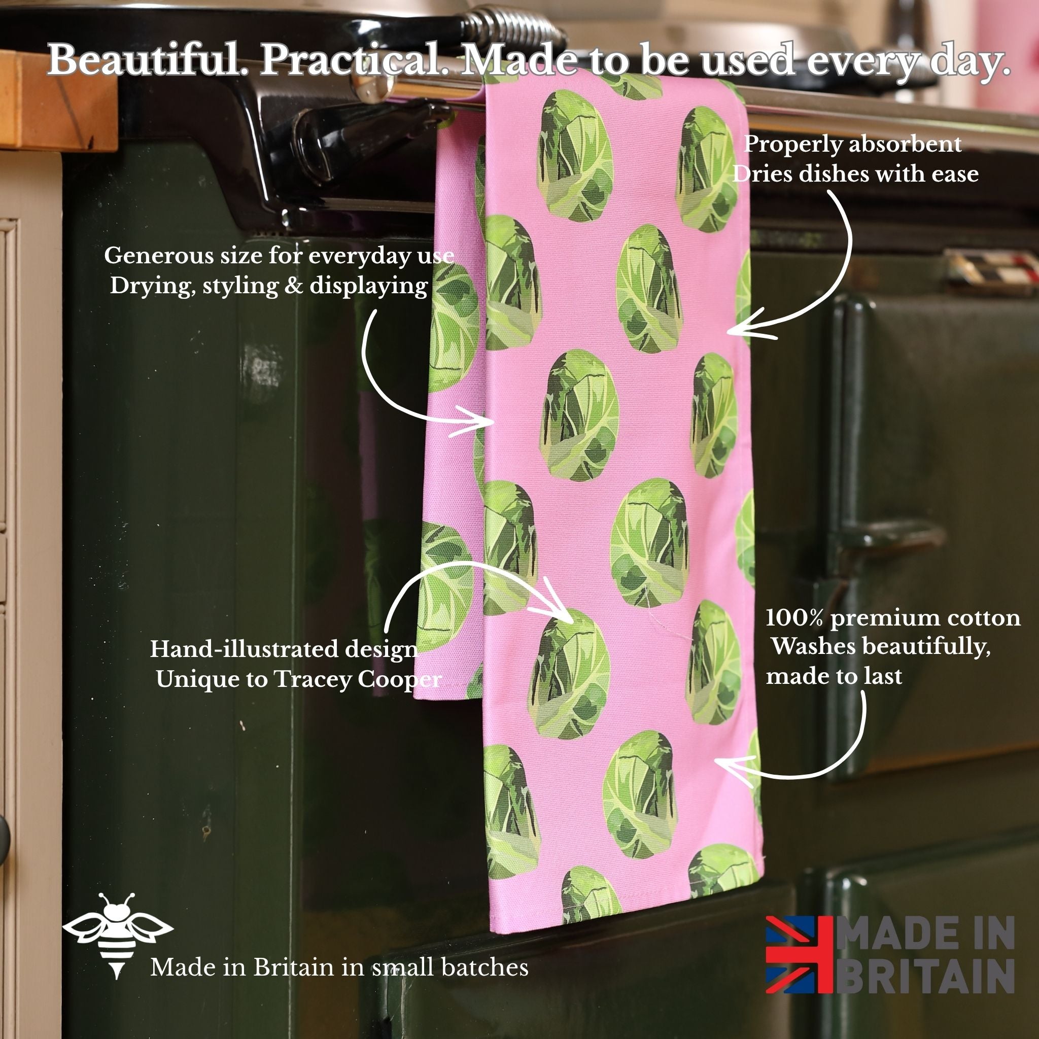 Pink towel with sprout pattern hanging on a kitchen rack, with text describing its features.