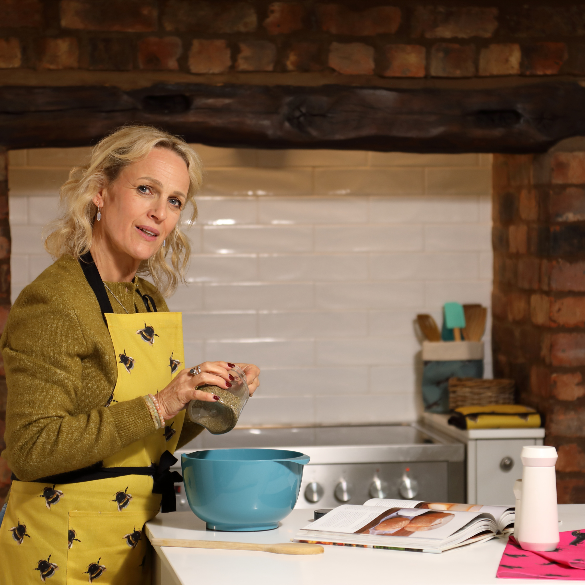 Hand-illustrated Bee Apron by Tracey Cooper — 100% cotton, printed in the UK, featuring bees on a sunny yellow background with pockets.