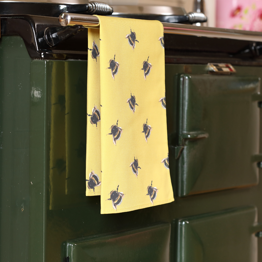 Hand-illustrated Bee Tea Towel by Tracey Cooper — 100% cotton, printed in the UK, featuring a detailed bumble bee design on a bright yellow background.