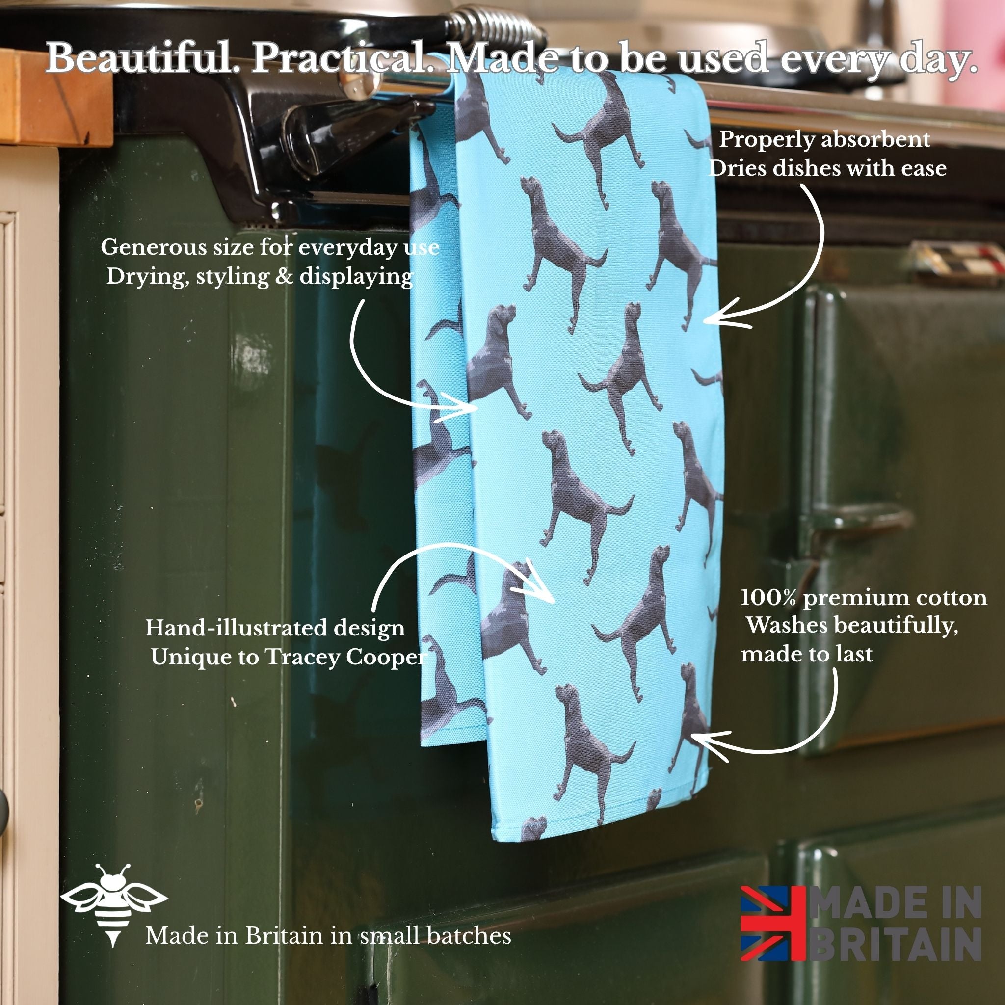 Blue towel with dog pattern hanging on a aga, with text describing its features.