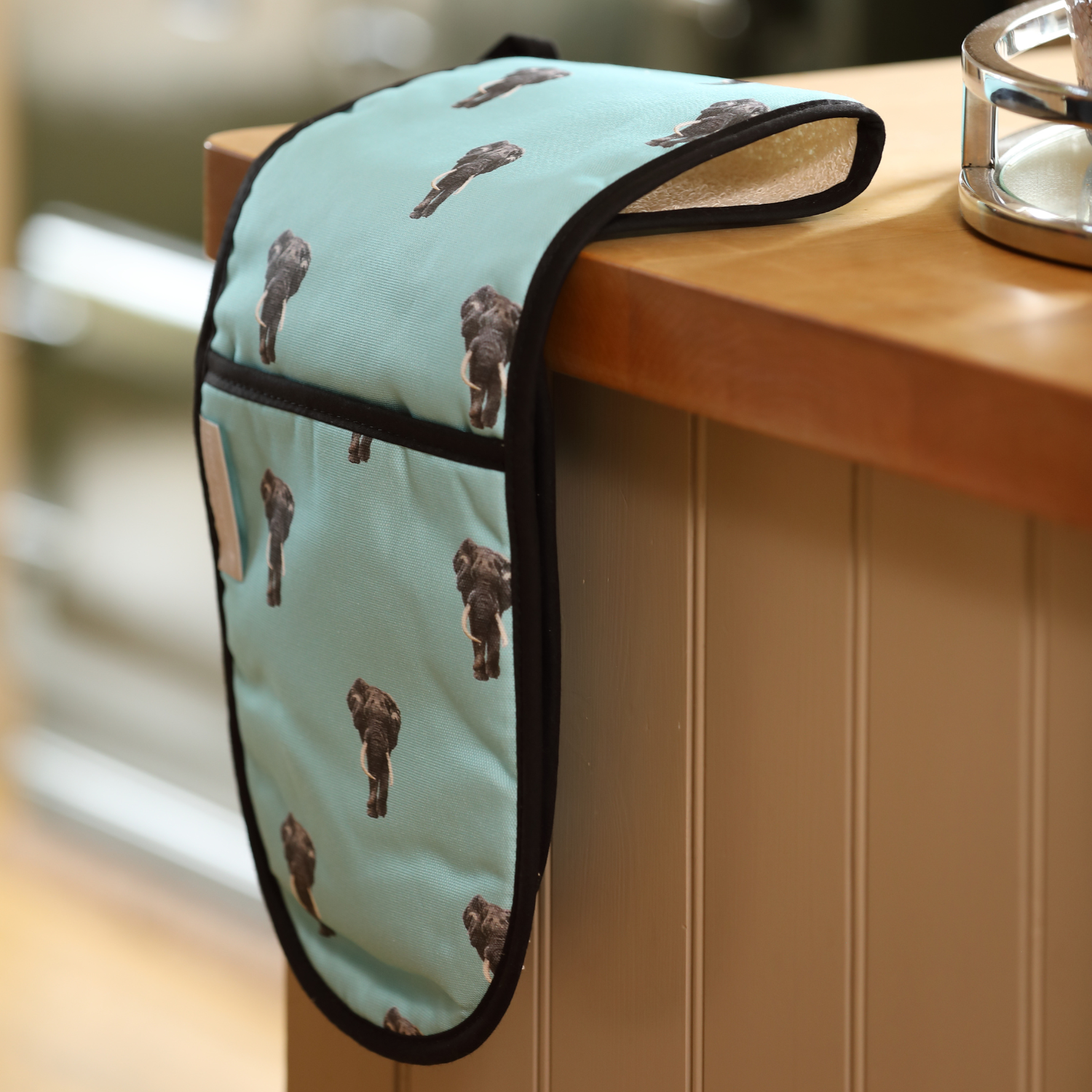 Hand-illustrated Elephant Double Oven Glove by Tracey Cooper — crafted from 100% cotton in pale blue to bring artistry and calm to your kitchen.