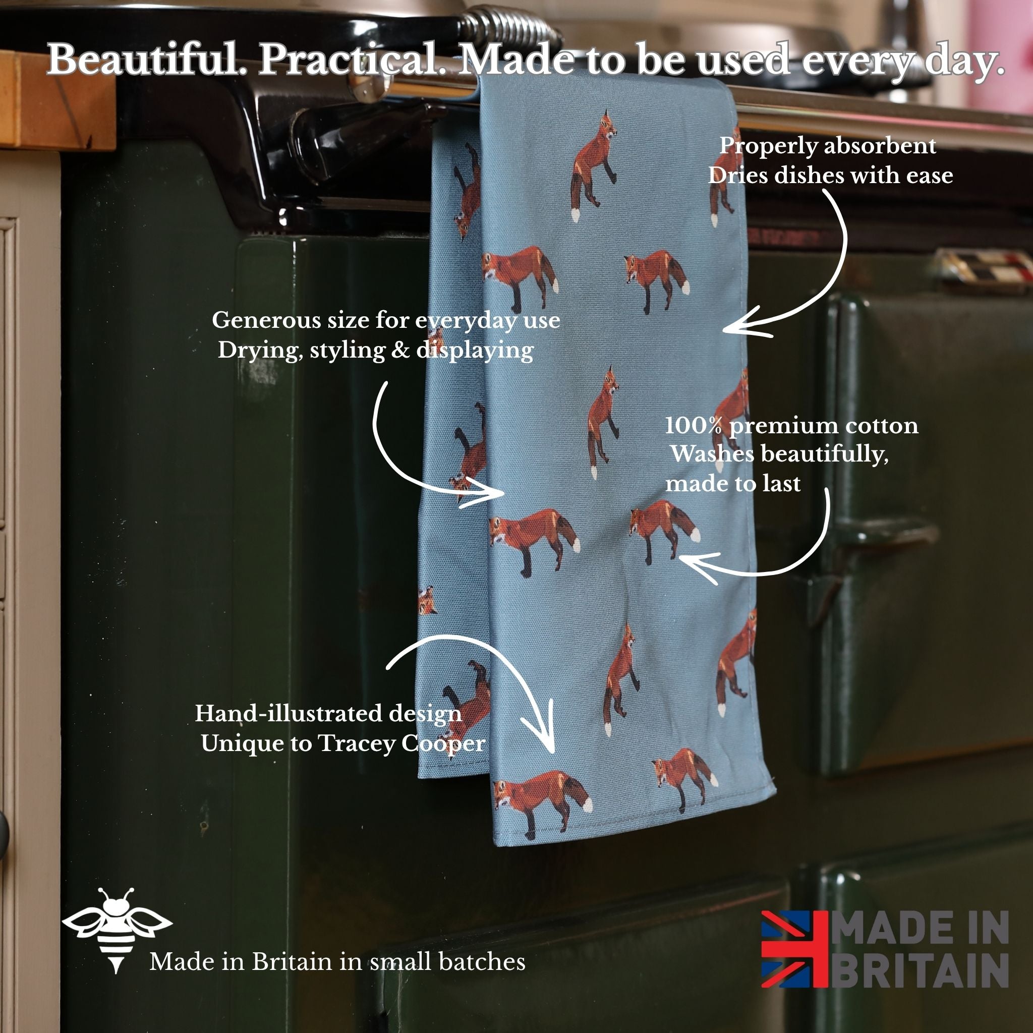Blue towel with fox pattern hanging on a kitchen rack, with text describing its features.