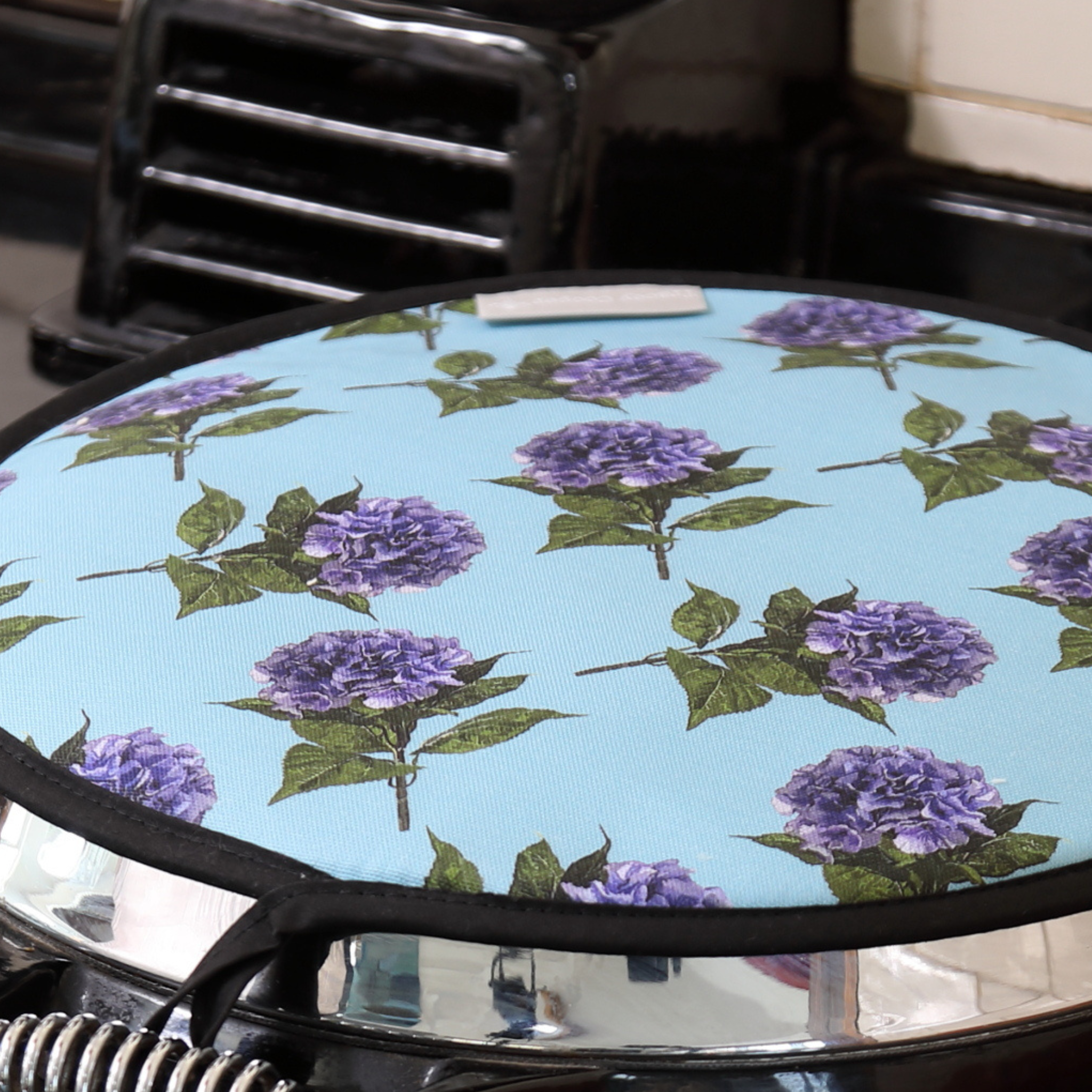 Hydrangea AGA hob cover styled on a range cooker in a colourful country kitchen