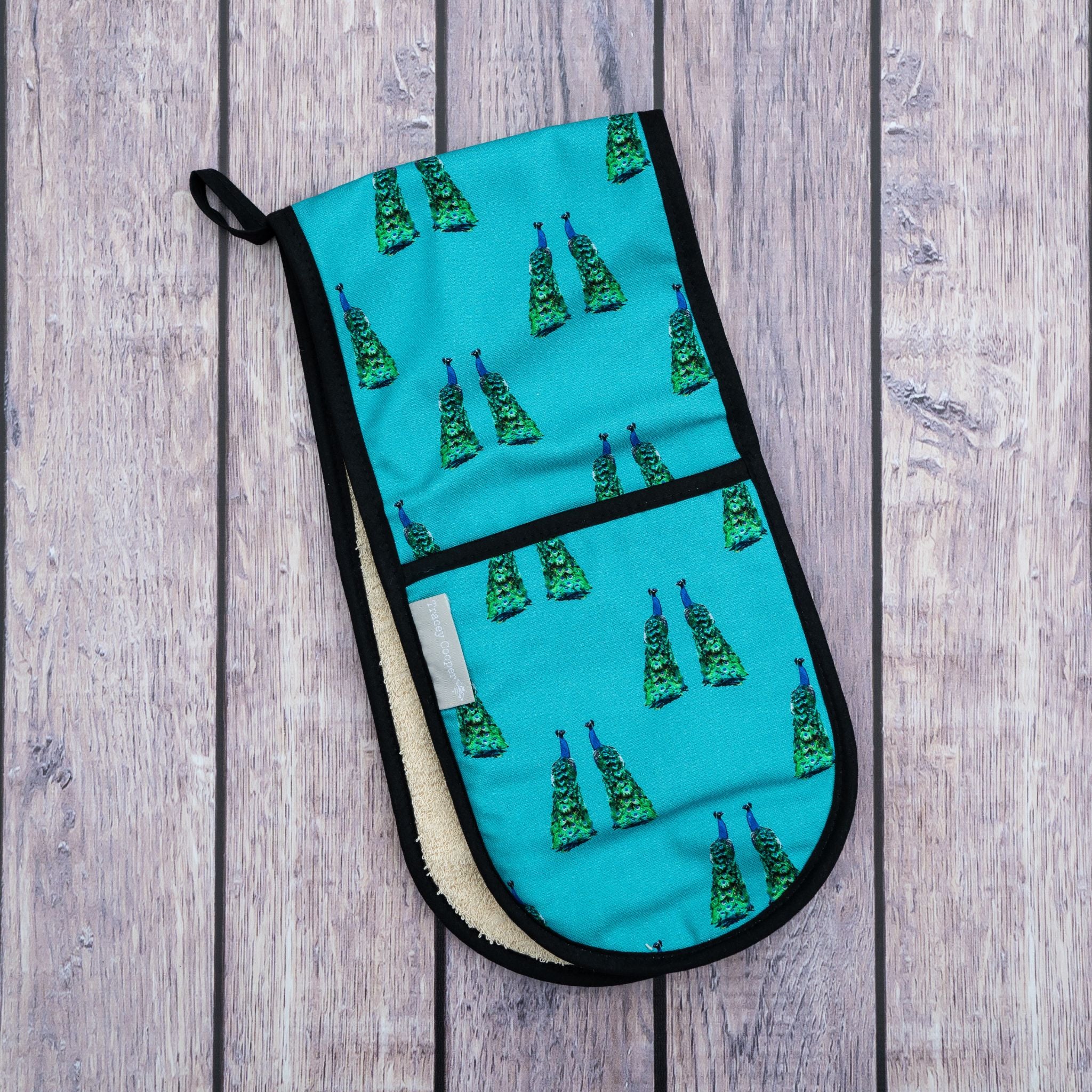 Peacock oven glove in blue
