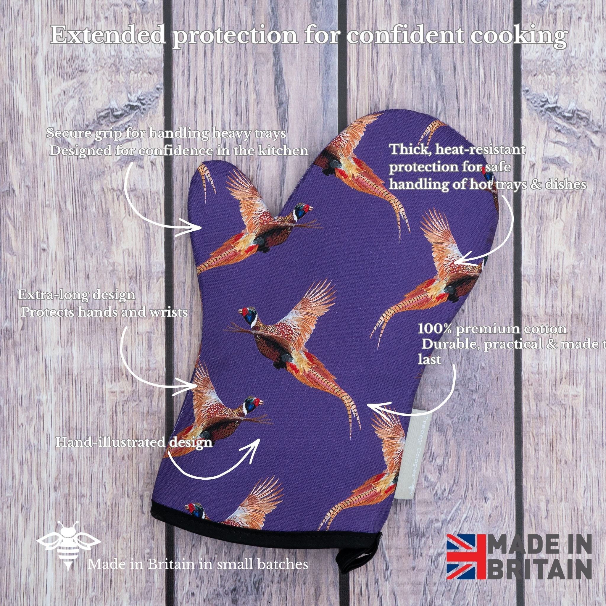 Purple oven mitt with pheasant design on a wooden background, featuring text about product features and 'Made in Britain' label.