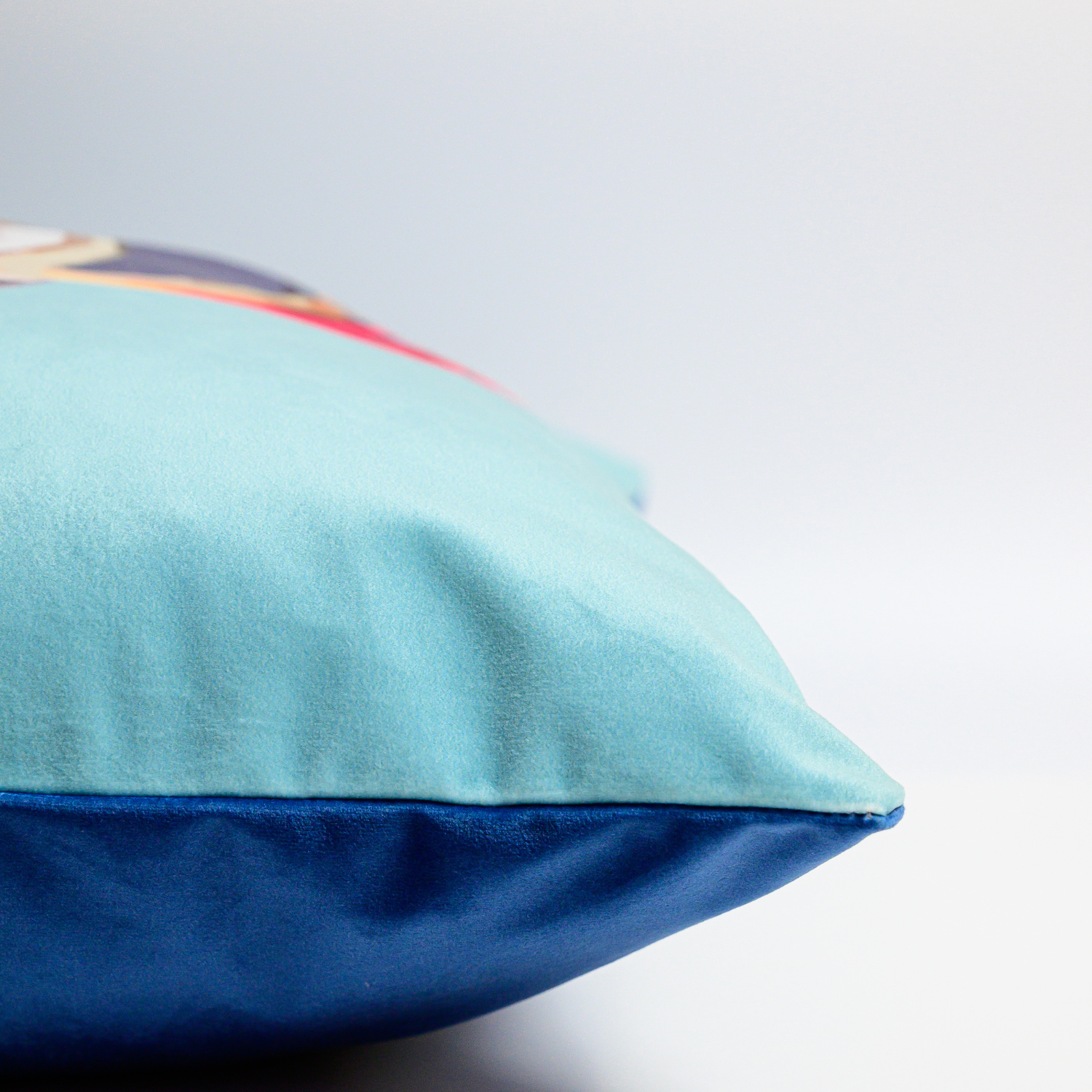 Puffin velvet cushion with hand-illustrated puffin design by Tracey Cooper side view