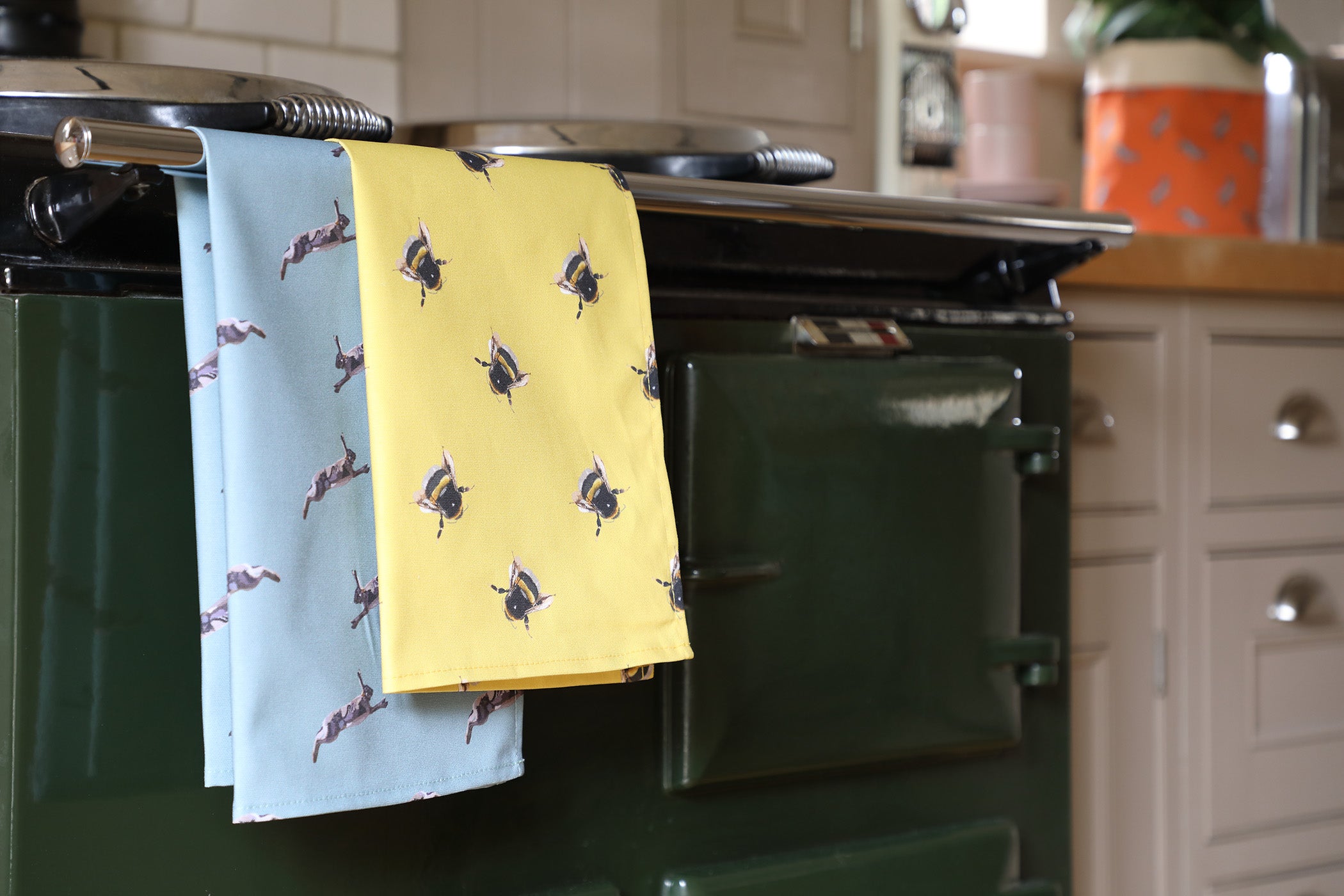 Yellow Bee Tea Towel and Hare Tea towel on an aga
