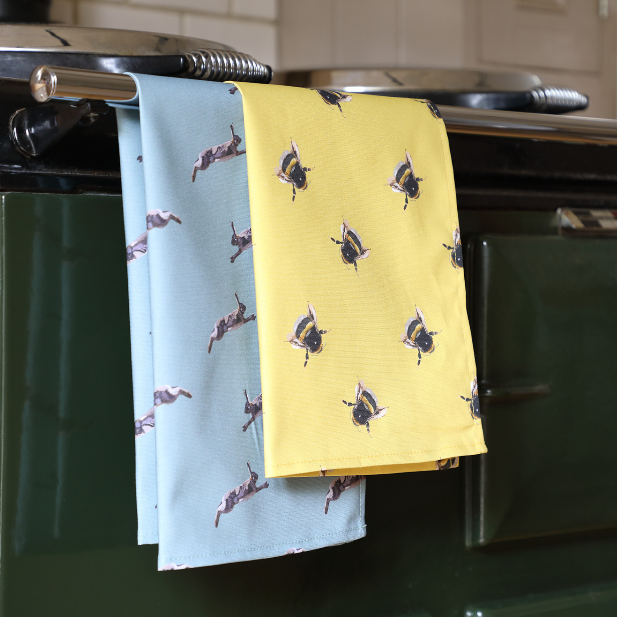 Styled set of two hand-illustrated British-made tea towels from Tracey Cooper Homeware.