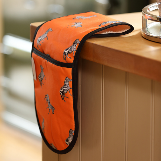 Hand-illustrated Zebra Double Oven Glove by Tracey Cooper — vibrant orange design crafted from 100% cotton, blending artistry, function, and bold style.