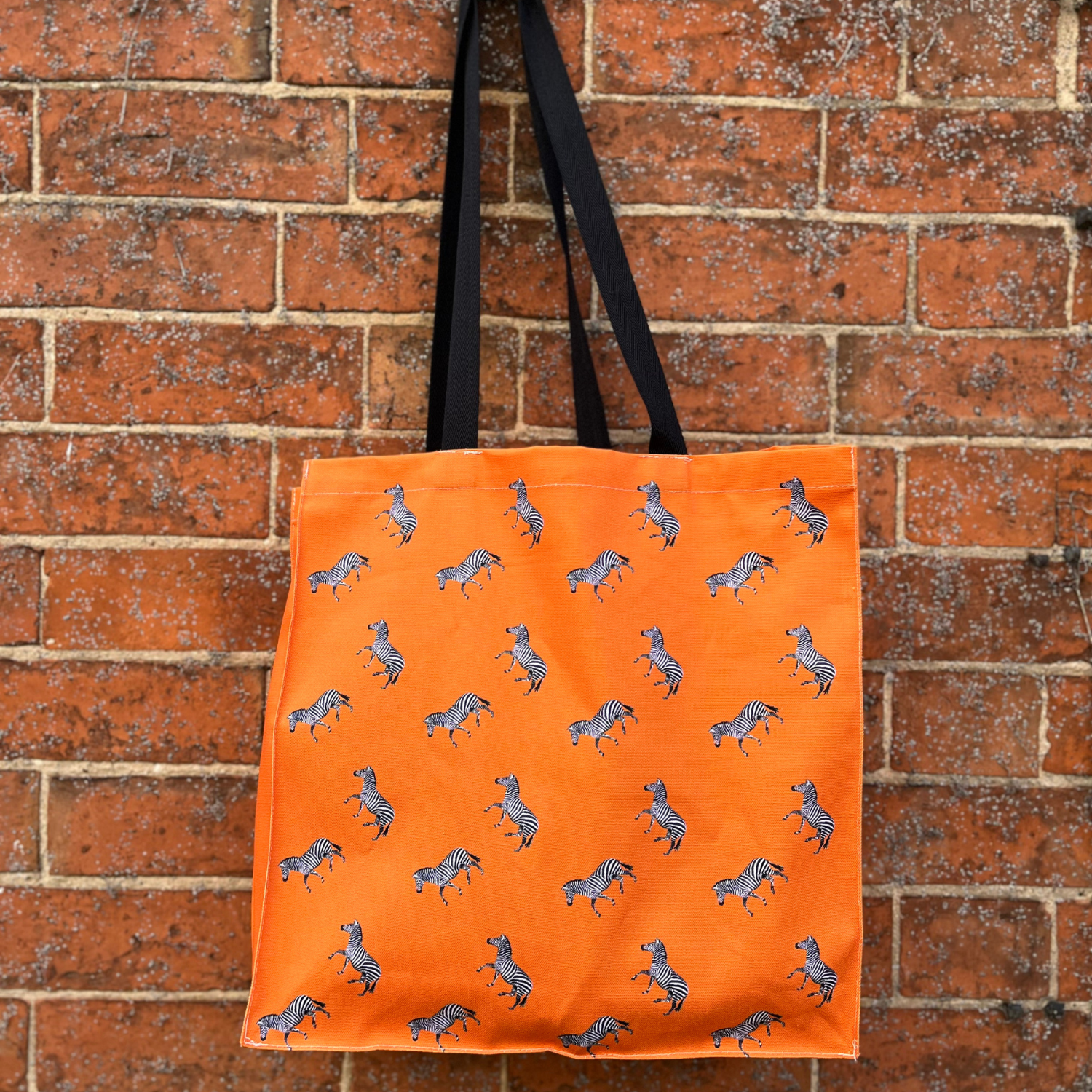 Orange zebra tote bag with repeat zebra pattern on back
