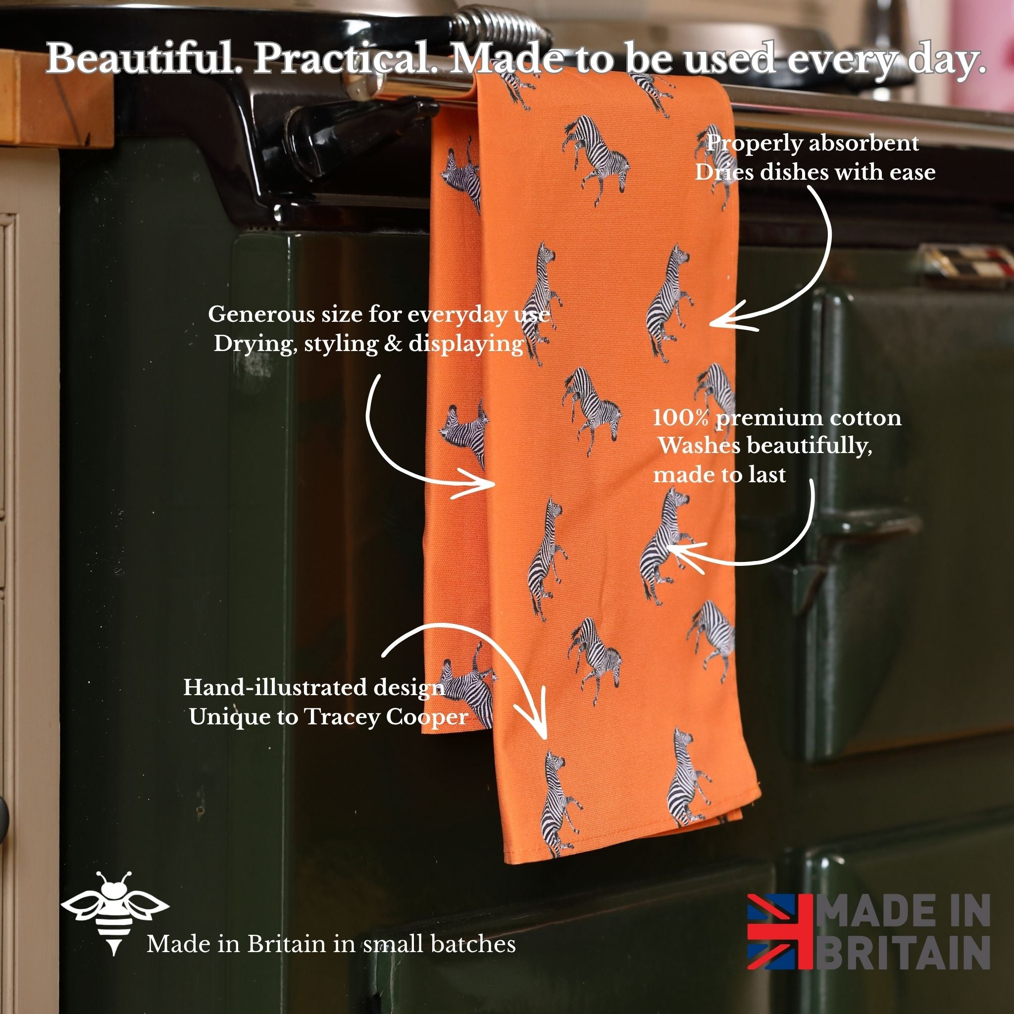 Orange towel with zebra pattern hanging on a kitchen rack, with text describing its features.