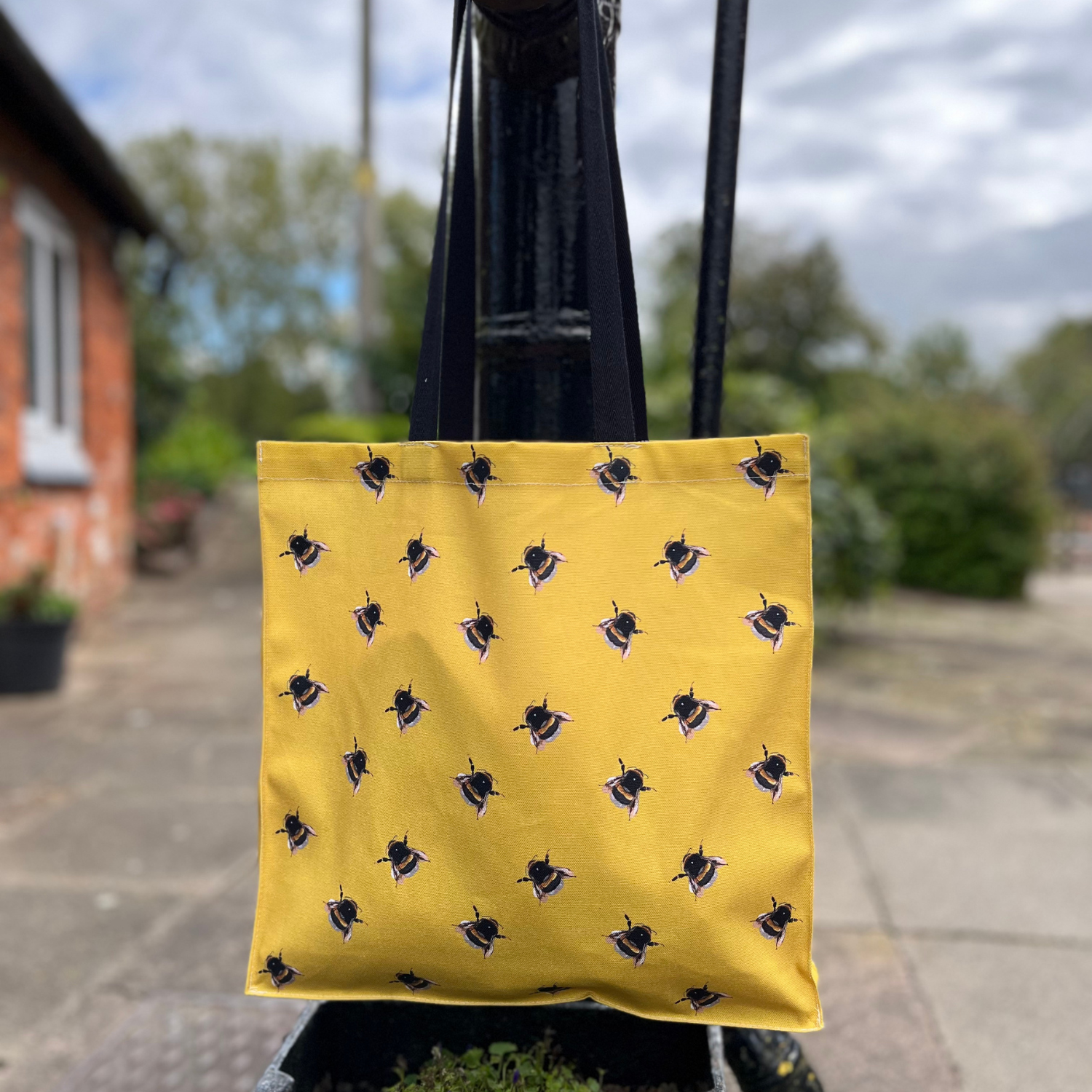 Bee tote bag with hand-illustrated bee on yellow background